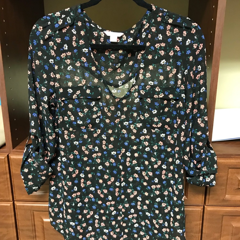 Women’s blouse with multicolored floral designs.